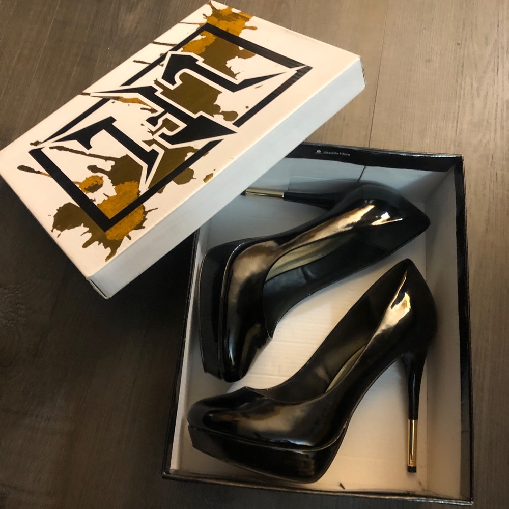 Black patent pumps with gold accent on heels